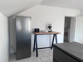 Eine moderne Küche mit einem Kühlschrank und einem Holzarbeitsplatz.