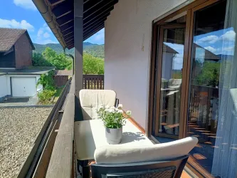 Der Balkon von Zimmer 3 mit Sitzgelegenheit und Blick auf den Pfälzerwald – ideal für den Feierabend nach einem Tag in den Weinbergen.