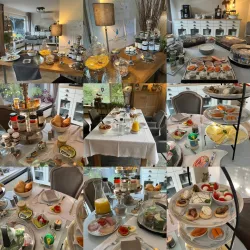 Ein schön gedeckter Tisch mit verschiedenen belegten Brötchen und süßen Leckereien. Dazu gibt es frisches Obst, Getränke und ansprechende Dekoration.