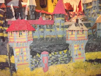 Eine bunte Burg mit roten Dächern und vielen Türmen. Die Struktur zeigt die Details von Mauern und Schilden.