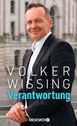 Ein Mann steht lächelnd vor einem historischen Gebäude. Der Name "Volker Wissing" und das Wort "Verantwortung" sind deutlich sichtbar.