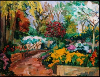 Ein bunter Garten mit vielen Blumen und bunten Sträuchern. Der Weg schlängelt sich durch die blühende Landschaft.