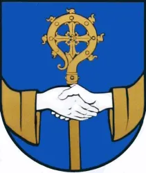 Ein Wappen mit einem blauen Hintergrund, das eine Hand zeigt, die einen goldenen Stab hält. Die andere Hand ist auch sichtbar und es scheint, als würden sich zwei Personen die Hände schütteln.