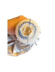 Zwei Stoffbeutel mit den Aufschriften "Ich bin mutig" und "Ich bin stark" liegen auf einer Fläche. Daneben sind verschiedene bunte Schlüsselanhänger und Armbänder platziert.