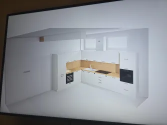 Eine moderne Küche mit weißen Möbeln und Holzoberflächen. Sie enthält einen Herd, eine Spüle und genügend Stauraum.