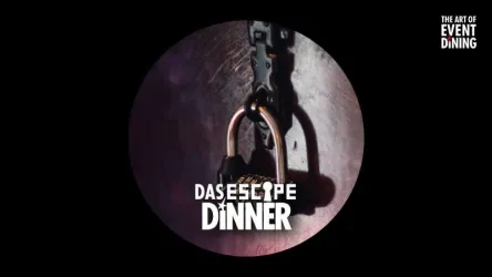 Ein geschlossenes Vorhängeschloss an einer Kette auf einem dunklen Hintergrund. Der Text „Das Escape Dinner“ ist prominent platziert.