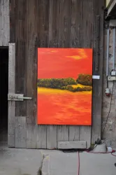 Ein farbenfrohes Gemälde mit warmen Orangetönen und einer Landschaft im Hintergrund. Das Bild hängt an einer rustikalen Holzwand.