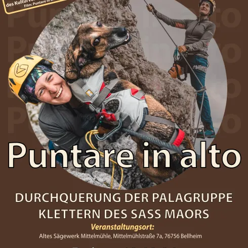 Ein Plakat für eine Multivisionsvortrag-Veranstaltung. Es zeigt eine Person mit einem Hund, die beim Klettern ist, und enthält Informationen über den Vortrag.
