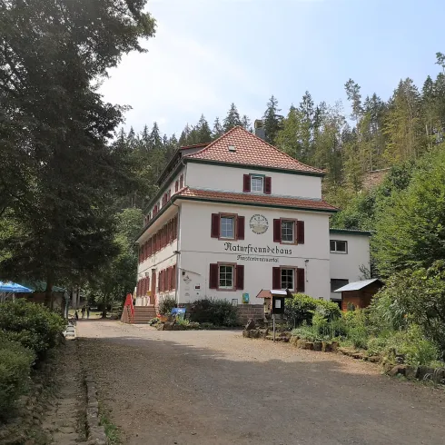 Ein charmantes Gebäude mit dem Namen "Kaufhauschloss" liegt umgeben von Bäumen. Die Gegend ist grün und einladend, ideal für einen ruhigen Aufenthalt.