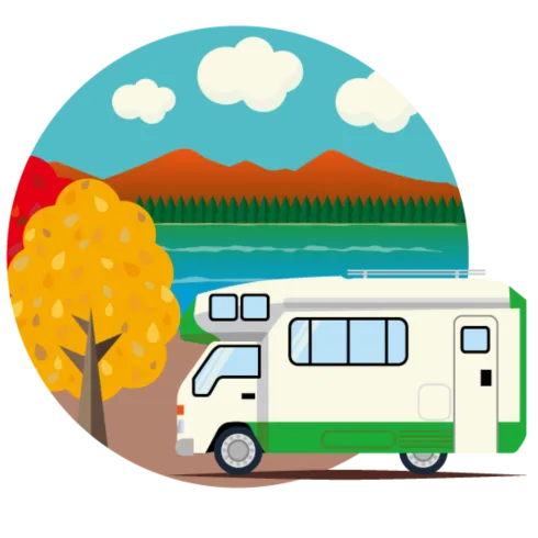 Ein Wohnmobil steht am Ufer eines Sees, umgeben von bunten Bäumen und Bergen im Hintergrund. Der Himmel ist klar mit einigen Wolken.