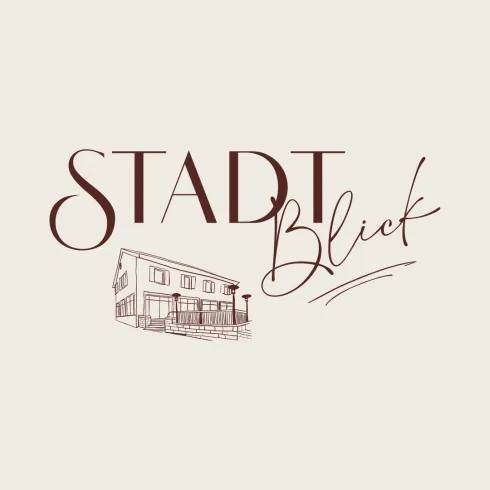 Ein stilvolles Logo mit dem Text "STADT Blick". Darunter befindet sich eine minimalistische Zeichnung eines Gebäudes.