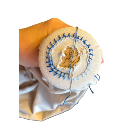 Zwei Stoffbeutel mit den Aufschriften "Ich bin mutig" und "Ich bin stark" liegen auf einer Fläche. Daneben sind verschiedene bunte Schlüsselanhänger und Armbänder platziert.